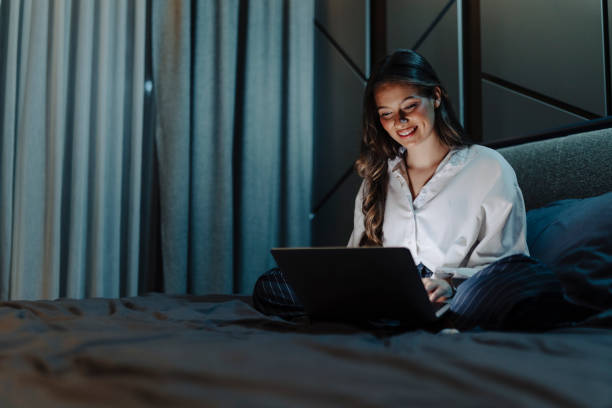 istock Woman working and using laptop at night 2186770328