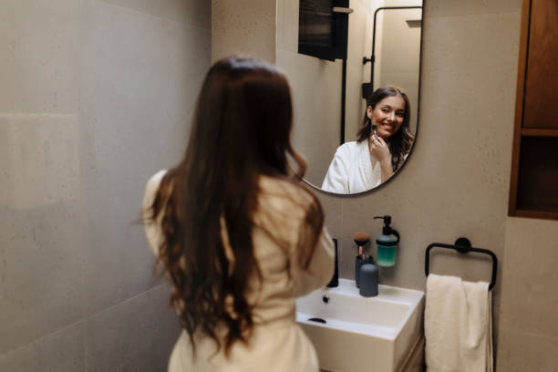istock Young woman putting on makeup 2186770388
