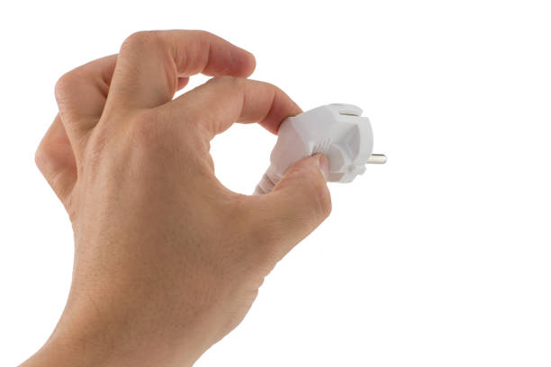 istock A close up of a hand holding a white electrical plug against a white background symbolizing power and connectivity 2186771475