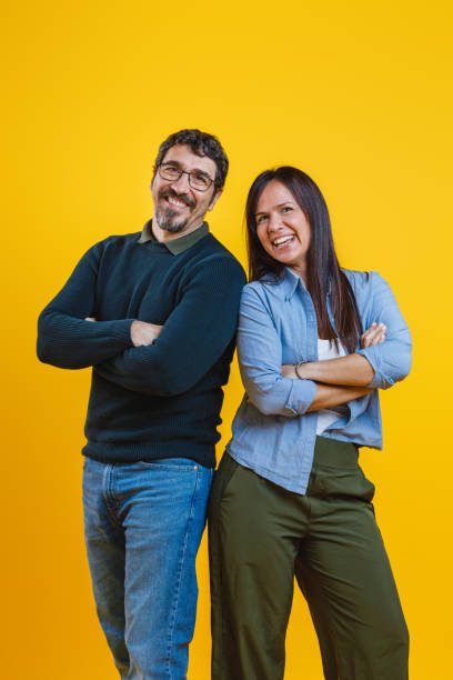 istock Cheerful Couple Enjoying New Beginnings, Yellow Studio Background 2186771995