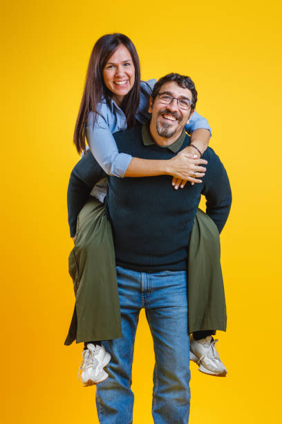 istock Joyful Couple Having Fun on Yellow Background 2186772014