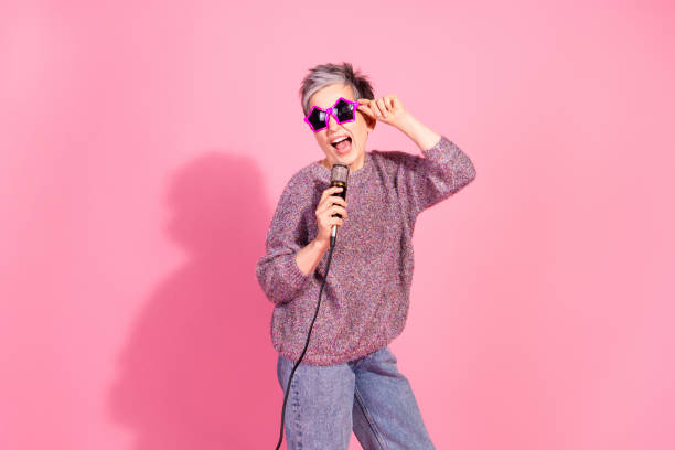 istock Photo of cheerful pretty lady dressed pullover singing songs mic empty space isolated pink color background 2186772187