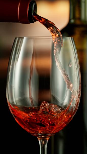 istock Close-up of red wine pouring into glass 2186772507