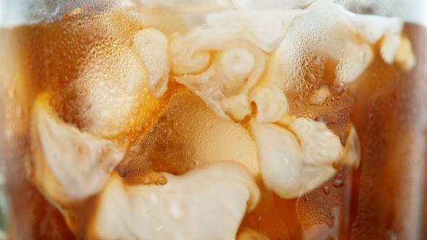 istock Macro Shot of Pouring Milk into Ice Coffee 2186772736