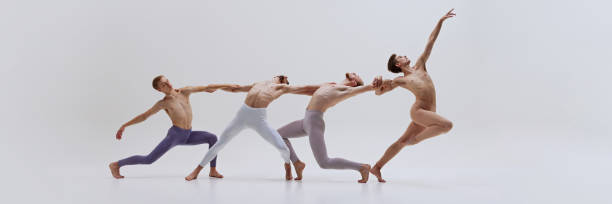 Banner. Dancers support each other, their bodies intertwined in sculptural pose that highlights their coordination and teamwork.