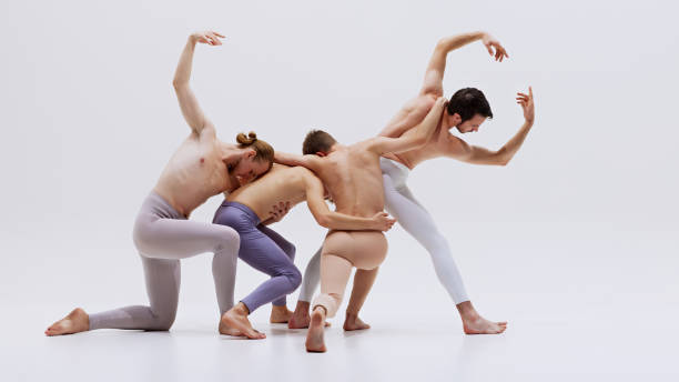 istock Ballet dancers create powerful visual as they dancing in unison, their athletic bodies reaching upwards in demonstration of training and artistic expression. 2186772759