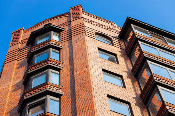 istock red brick facade loft architecture modern building exterior city scape view foreshortening from below with perspective lines and blue sky 2186772763
