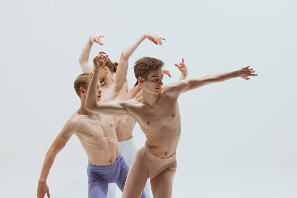 istock Close-up on three dancers emphasizes elegance and emotion conveyed through their performance against white studio background. 2186772771