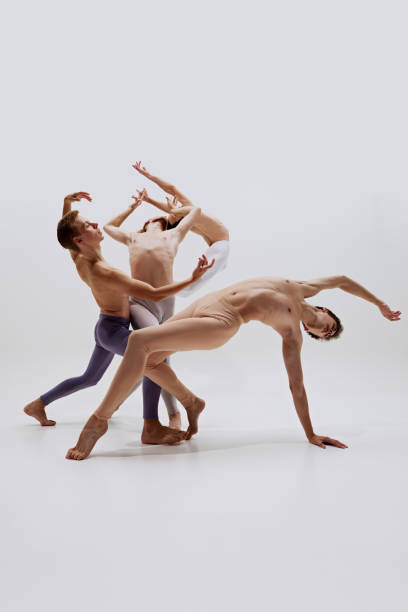istock Balanced between control and freedom, ballet dancers' forms carve space with each movement against white studio background. 2186772784