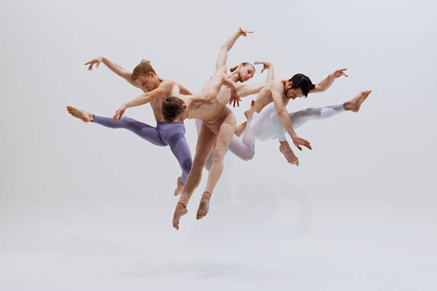 istock Dancers in mid-air, exercising control and precision, their leaps creating beautiful visual rhythm. against white studio background. 2186772800