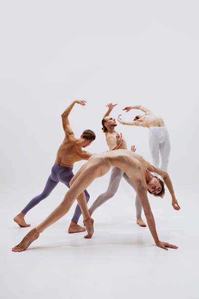 istock Fluidity of dancers' movements contrasts with their sharp lines, creating visual dialogue of tension and release. 2186772808