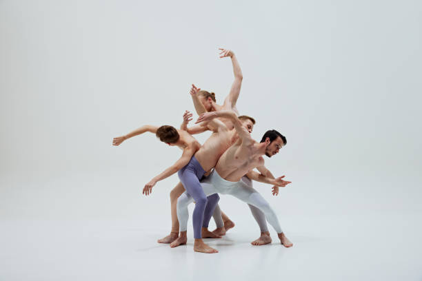 istock Ballet dancers' expressive and precise movements highlight their skill and emotional depth against white studio background. 2186772809
