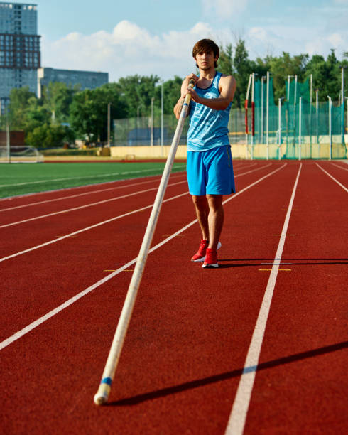 istock Pole vaulter in training session at outdoor stadium, standing with pole, showing strength and determination, aiming for high jump performance 2186776030