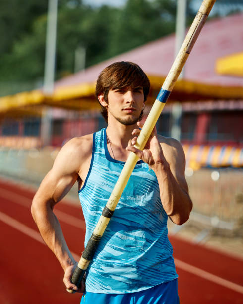 istock Focused man, pole jump athlete working on pole vaulting technique, growing skills for competition, training at outdoor stadium 2186776031