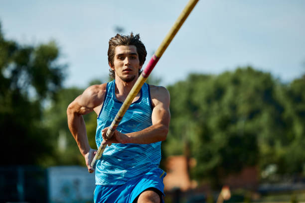 istock Pole vaulting athlete training on outdoor stadium track, aiming for new heights, focused muscular man running with pole, showing skills 2186776078