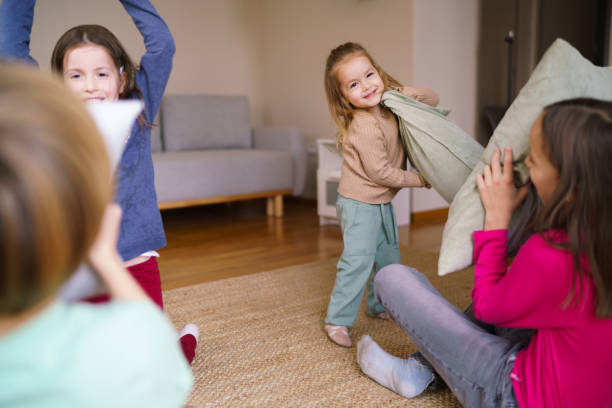 istock Children having fun in pillow fight at home 2186776604