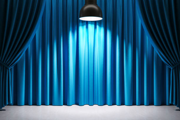 istock Empty stage with blue curtains and spotlight shining down in the center. Classic theater scene prepared for a show or performance. 3D Rendering 2186777248