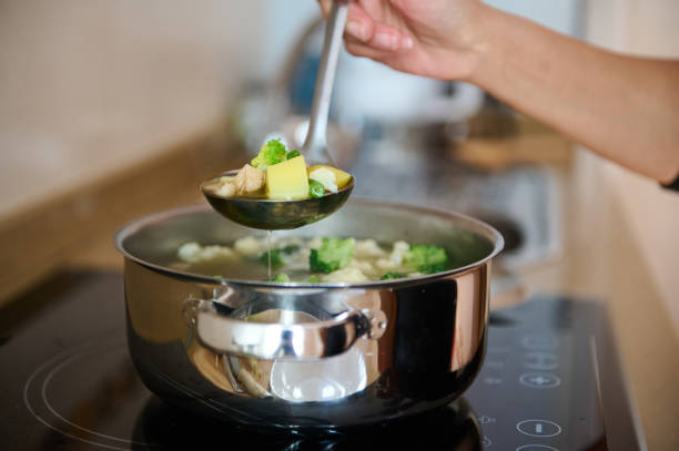 istock Hand stirring homemade soup with vegetables on stovetop 2186777610