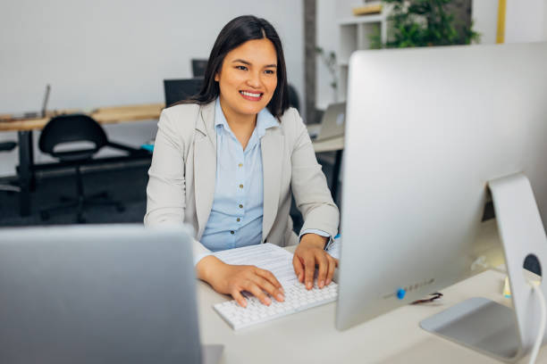 istock Filipino female entrepreneur using computer while working in the office. Copy space 2186779714