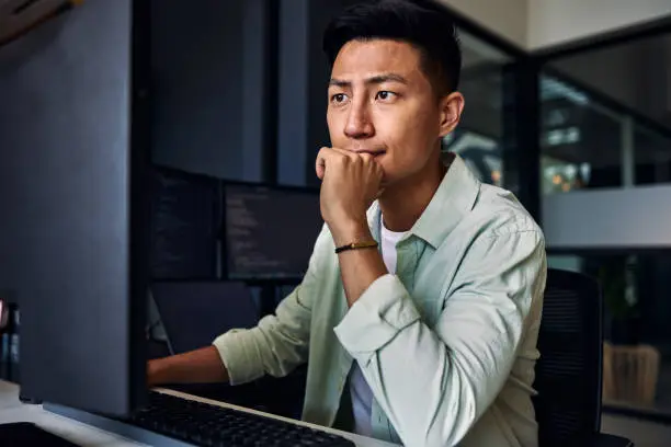 Photo of Young asian man working as software developer, coding on computer in modern office