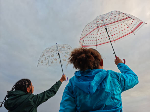 Children with Umbrellas on a Cloudy Day.