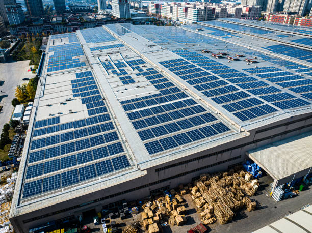 Solar panels mounted on factory roof for producing green ecological electricity Solar panels mounted on building roof for producing green ecological electricity solar panels on the roof of building in a city stock pictures, royalty-free photos & images