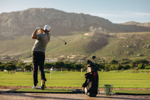 istock Man practicing his golf swing surrounded by beautiful outdoor mountain scenery 2186783308
