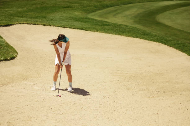 istock Female golfer taking a stance for precision aiming preparing for a bunker escape 2186783468