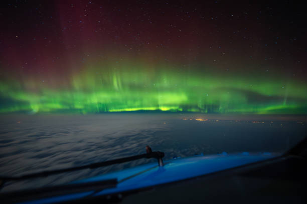 istock Cockpit pilot view of Aurora Borealis Northern Lights above clouds 2186783860