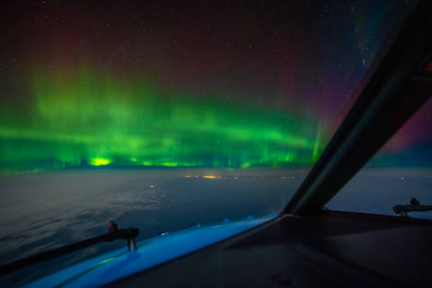 istock Cockpit pilot view of Aurora Borealis Northern Lights above clouds 2186783878