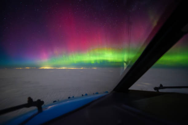istock Cockpit pilot view of Aurora Borealis Northern Lights above clouds 2186783884