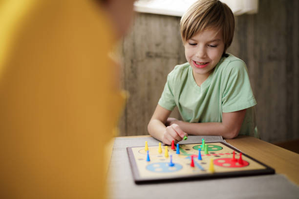 istock Happy boy playing Ludo game whit his friend 2186790384