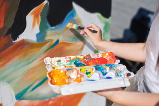 istock Female painter hand passionately paints picture with paintbrush 2186790488