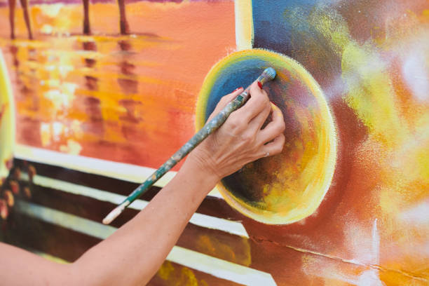 istock Female painter hand draws picture with paintbrush on canvas 2186790931