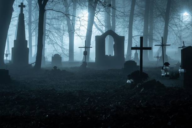 istock Foggy graveyard at night with eerie shadows 2186791406