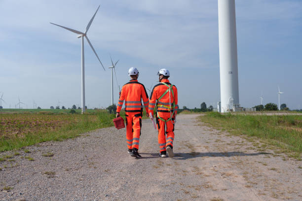 istock Surveyor and engineer Examine the efficiency of gigantic wind turbines that transform wind energy into electrical energy that is then used in daily life. 2186795412