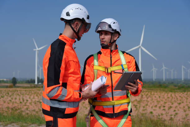 istock Surveyor and engineer Examine the efficiency of gigantic wind turbines that transform wind energy into electrical energy that is then used in daily life. 2186795597