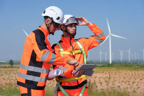 istock Surveyor and engineer Examine the efficiency of gigantic wind turbines that transform wind energy into electrical energy that is then used in daily life. 2186795627