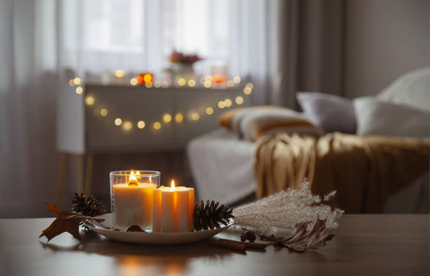istock autumn and winter home decor with burning candles 2186797496