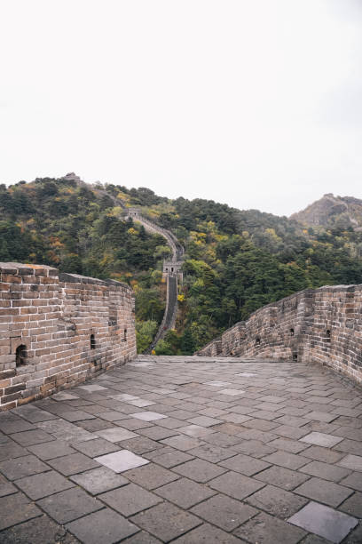 istock Great Wall of China, path with brick wall and multiple steps between the watchtowers, surrounded by alpine forest in autumn day with fog; near Beijing, China 2186800520