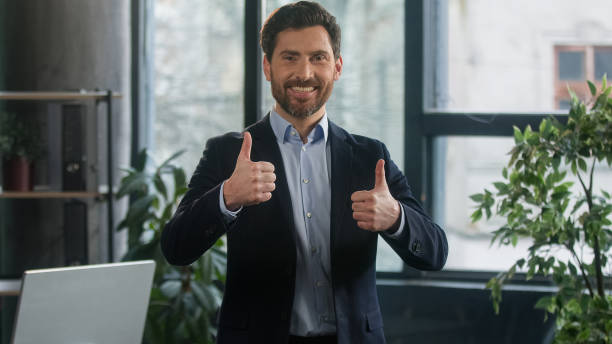 istock Focused adult caucasian man recruiting agent standing in office making notes writing checklist businessman conducts inspection write strategic plan showing thumb up gesture approval best choice sign 2186801182
