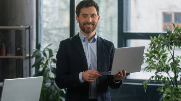 istock Focused adult caucasian man recruiting agent standing in office making notes writing checklist businessman conducts inspection write strategic plan showing thumb up gesture approval best choice sign 2186804321