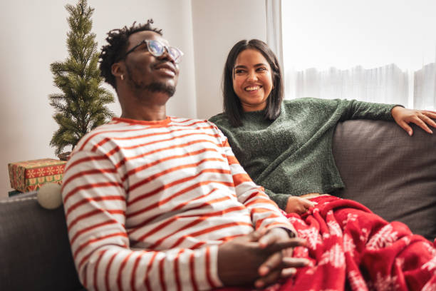istock Couple enjoying a cozy holiday moment on the sofa 2186808191