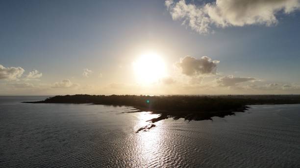 istock Sunset over calm sea and coastline 2186808210