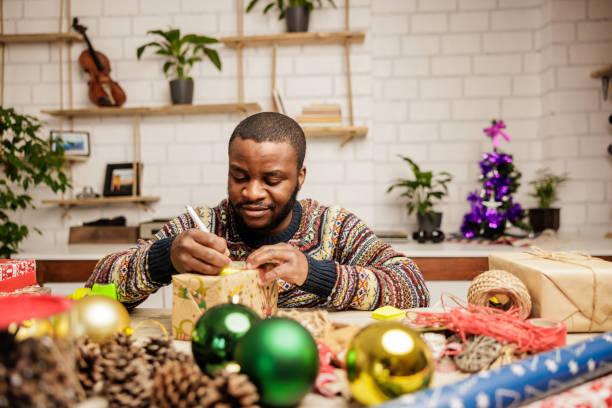 istock Man writes on a Christmas card 2186810304