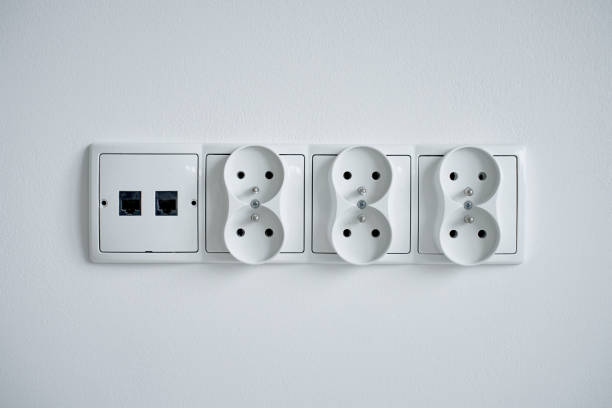 istock White electrical sockets and ethernet ports on white wall 2186810466