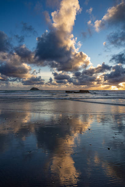 Beautiful Muriwai Beach covered with clouds at sunset