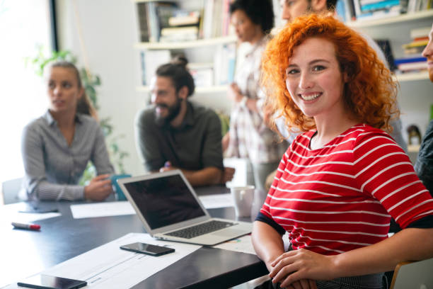 istock Diverse group of happy employees analyzing reports with digital device, working together in office 2186810715