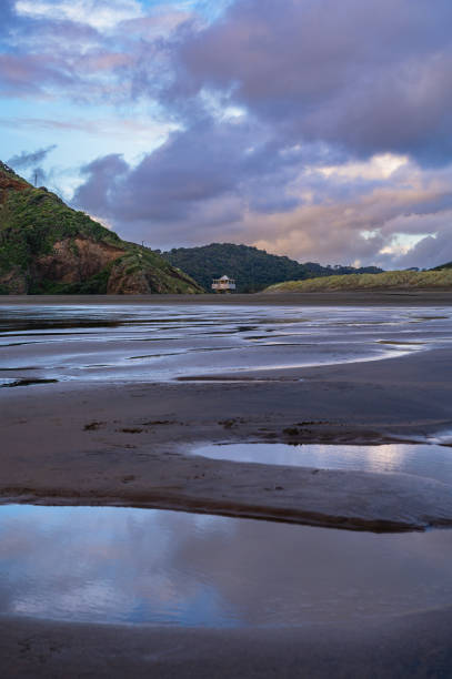 istock Reflective sunset moment at the Bethells Beach 2186811786