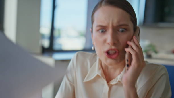 istock Furious businesswoman shouting smartphone holding work documents closeup. 2186812078